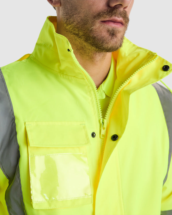 Roly Merak parka in green and fluorescent yellow, chest pocket, ID holder and zip detail.